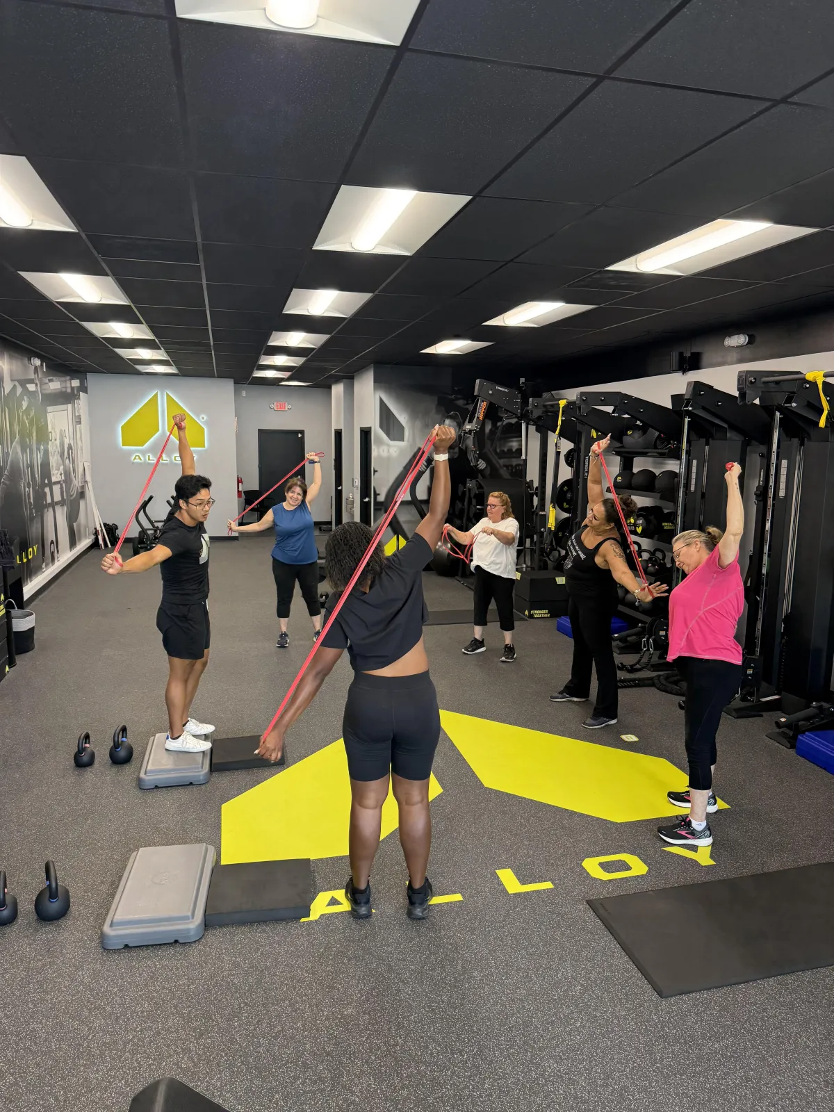 Head Trainer with a small group personal training session of 6 people who just started their first workout ever