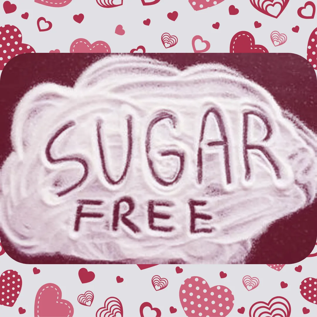 sugar particles on a pink wooden floor with some sugar falling off a wooden spoon on the floor and lo sugar inscribed on the sugar particles