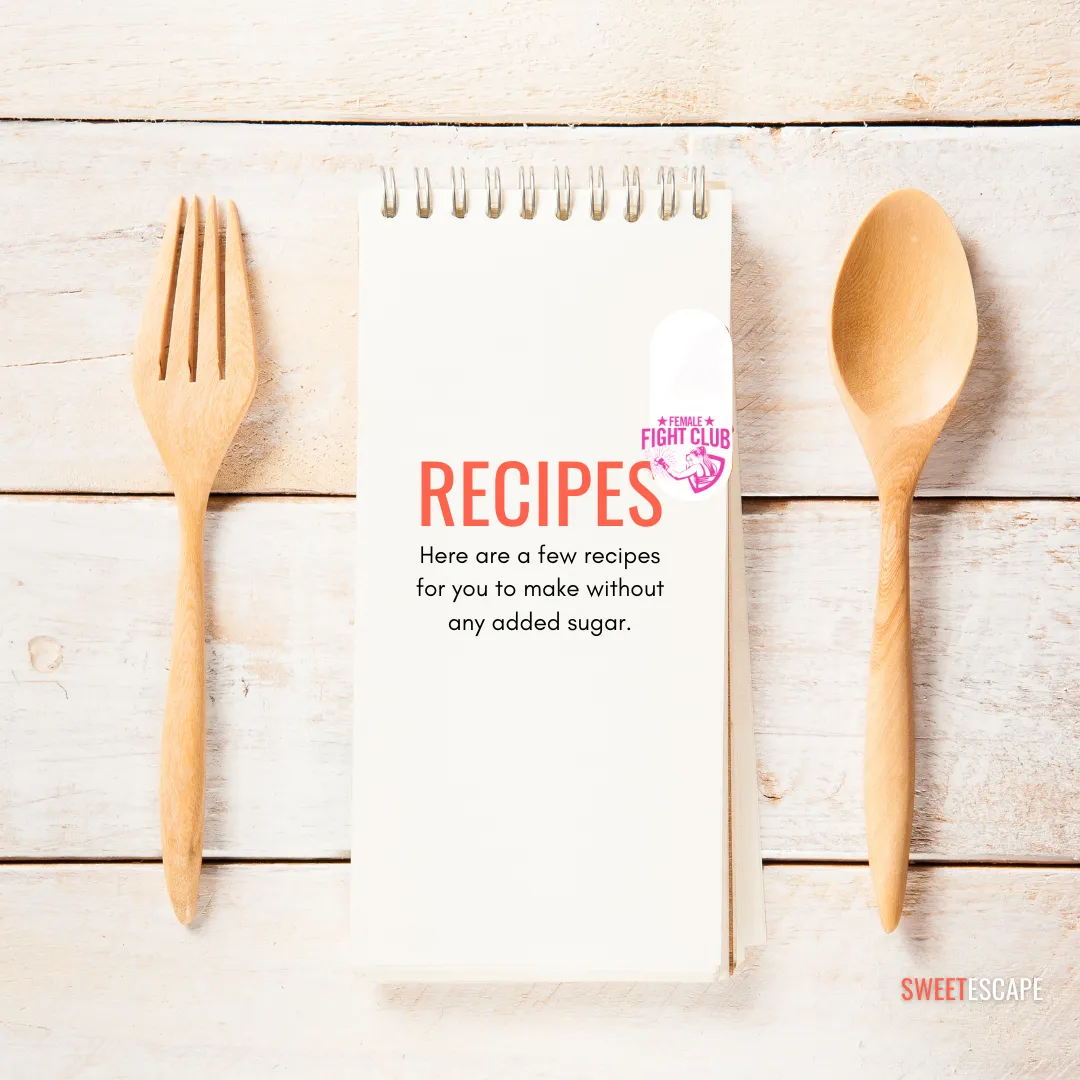 wooden background, a wooden fork and spoon with a mini book with spiral rings holding it and Recipes written on it.