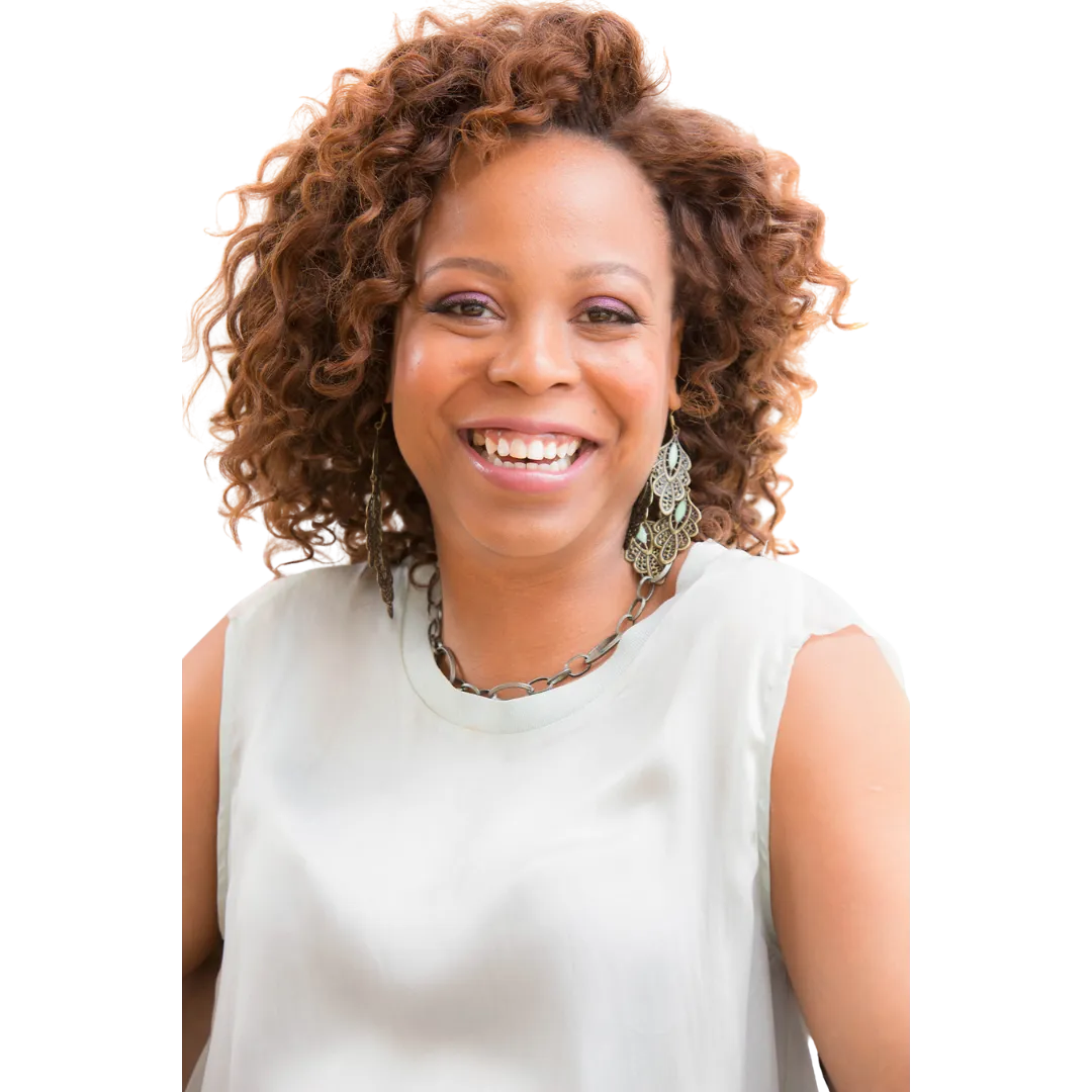An African American woman with wide smiles and short brown curly hair wearing an ash coloured top