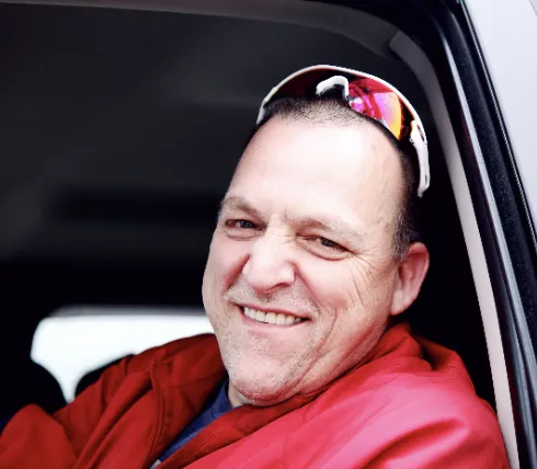 Smiling man sitting in car