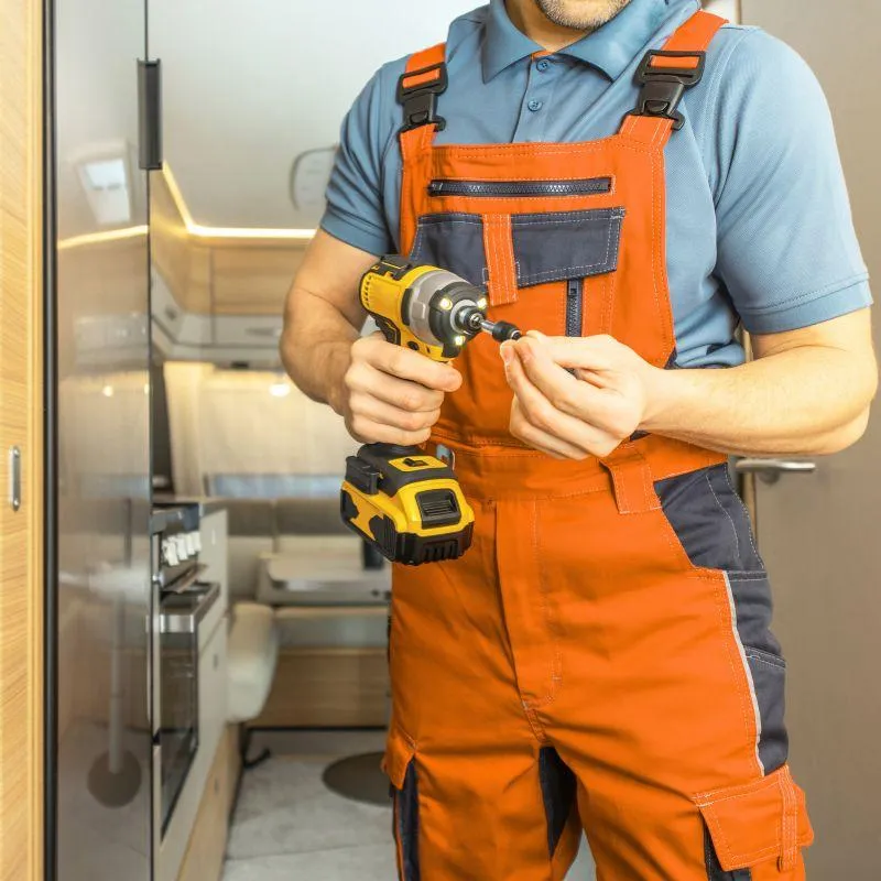 Man repairing a RV vent