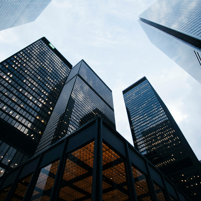 Team of four financial professionals, two men and two women, diverse backgrounds, standing together in a bright office, collaborative atmosphere, business attire, 3:2 aspect ratio