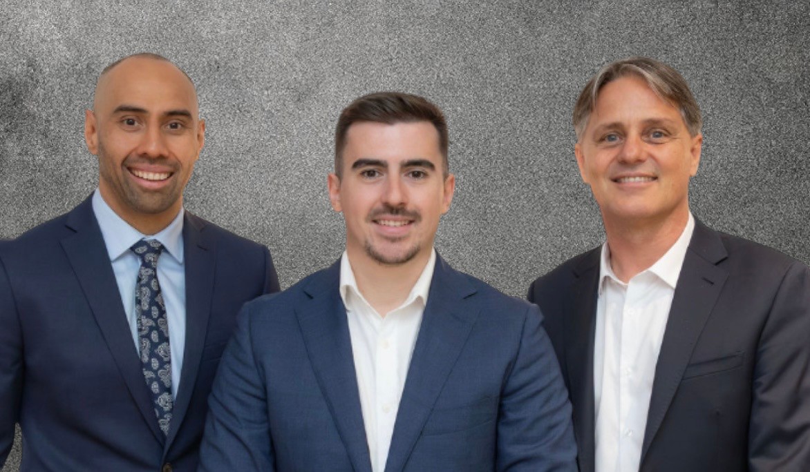 Team of four financial professionals, two men and two women, diverse backgrounds, standing together in a bright office, collaborative atmosphere, business attire, 3:2 aspect ratio