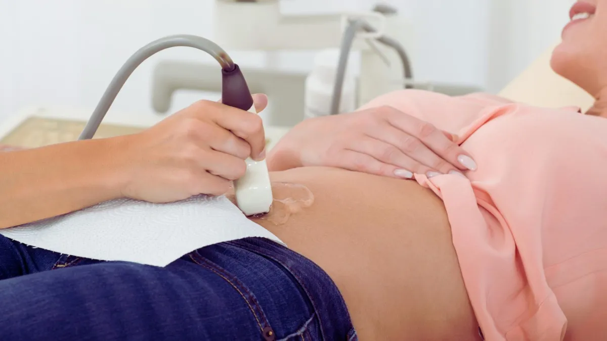 Medical professional performing an abdominal ultrasound.