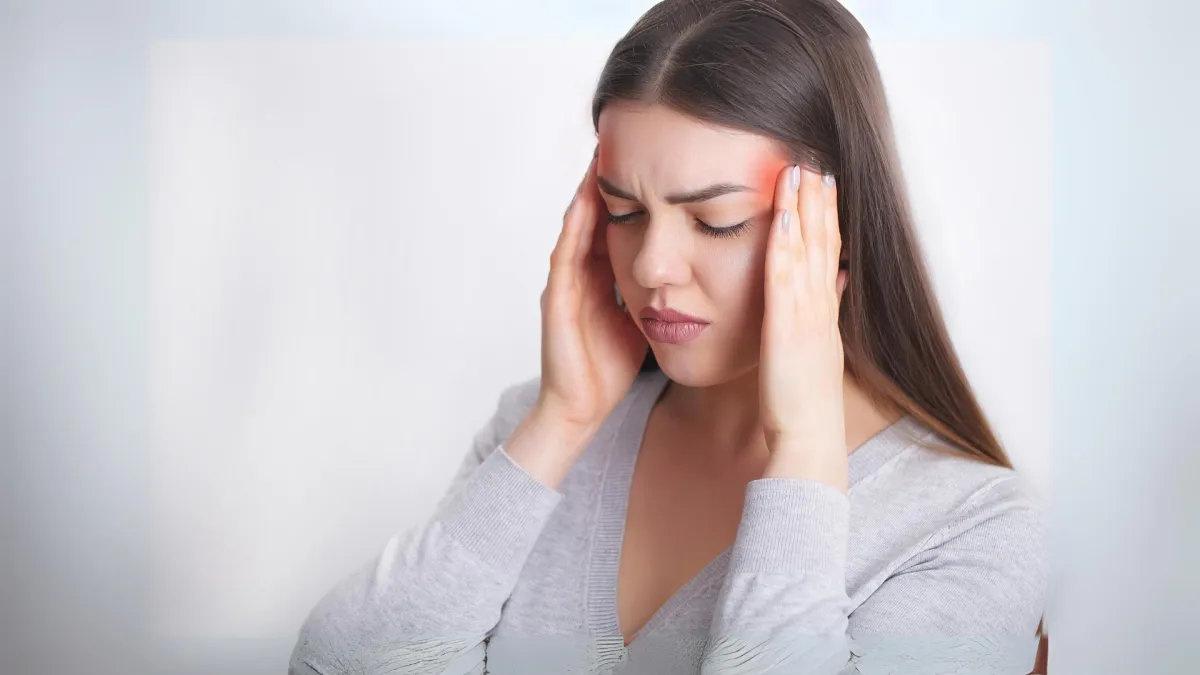 Woman experiencing a severe headache.