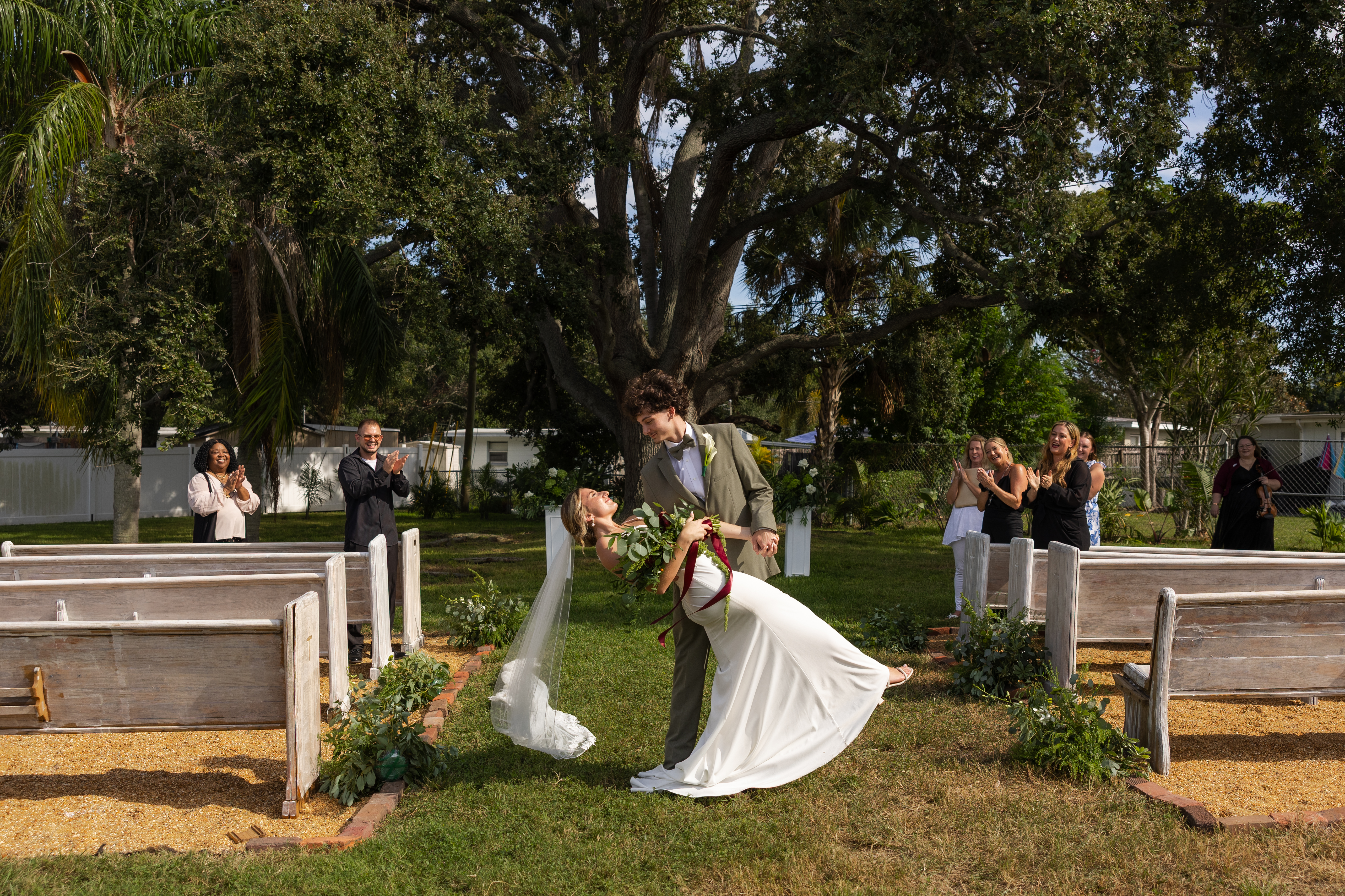 A wedding party on a balcony inside a grand building.