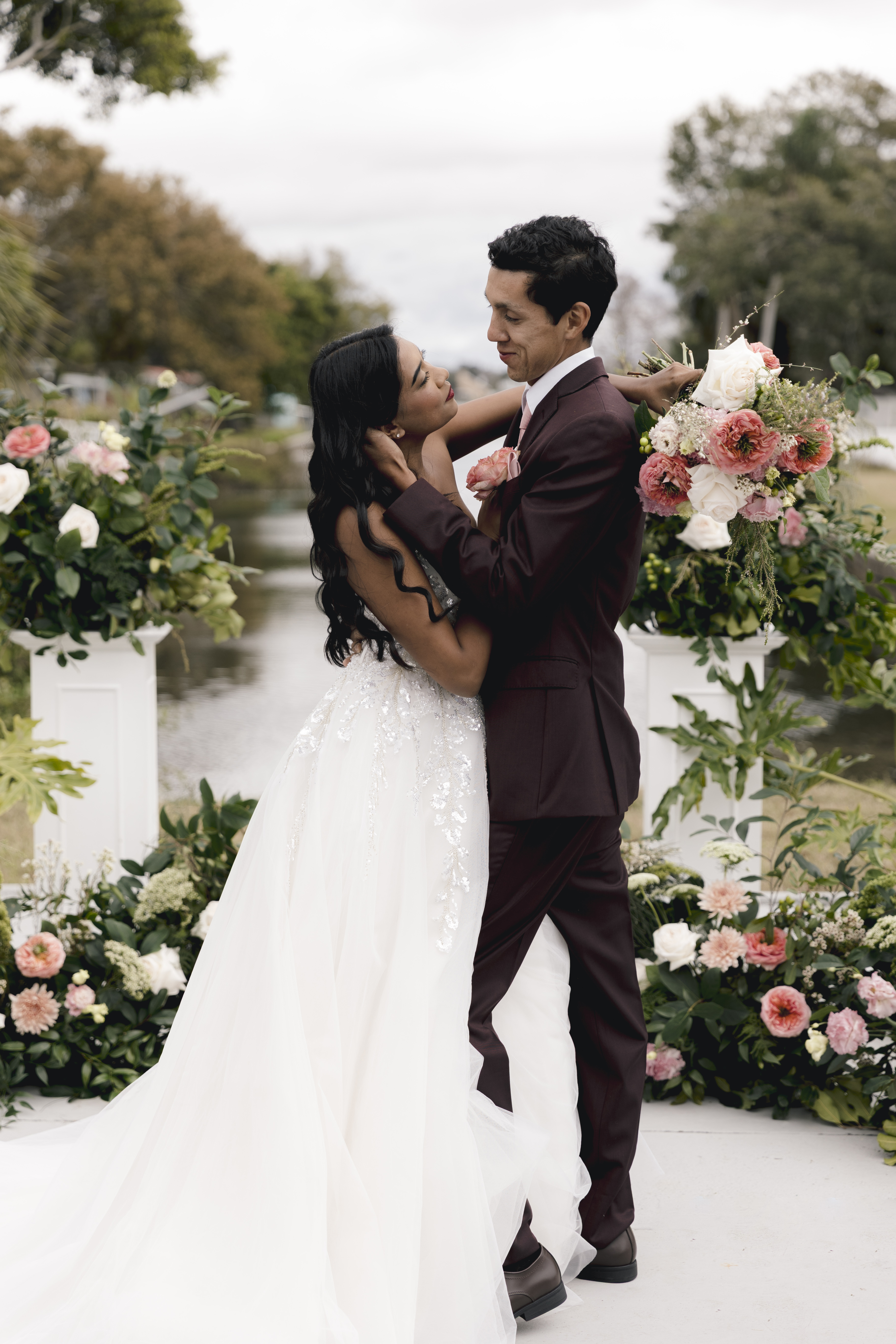 Wedding party celebrating outdoors with bouquets