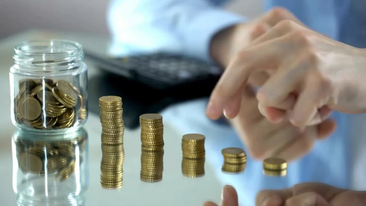 A piggy bank wearing glasses next to a calculator.