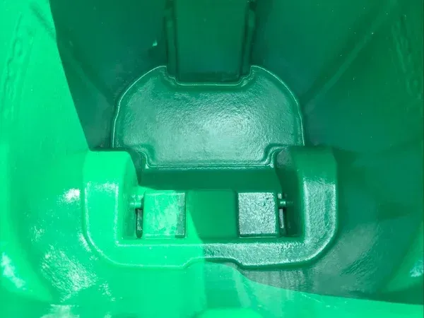 Close-up view of a freshly cleaned green trash bin interior