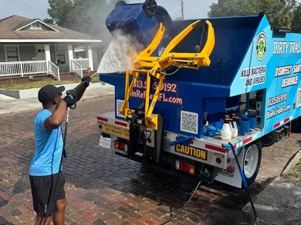 Family standing in front of their trash can cleaning service truck, showcasing their eco-friendly and professional business.