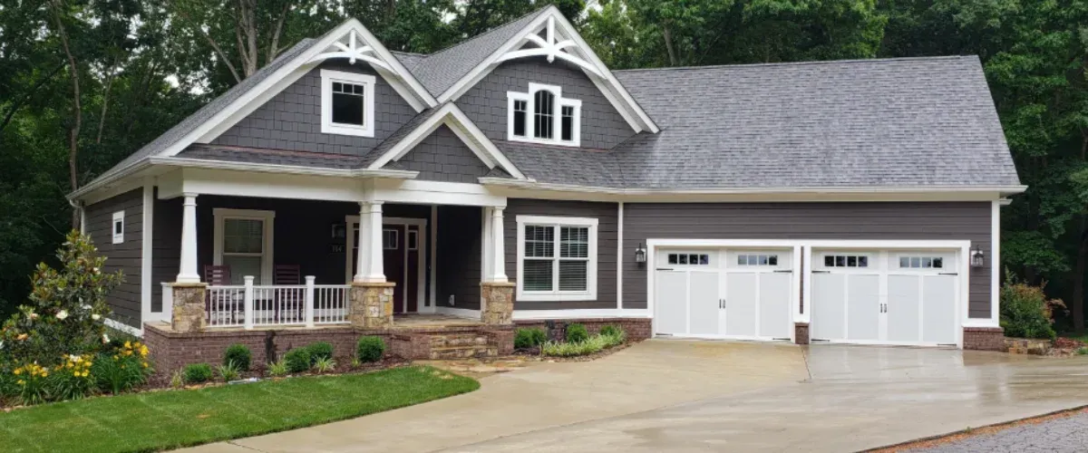 Residential home exterior with clean driveway and landscaped yard