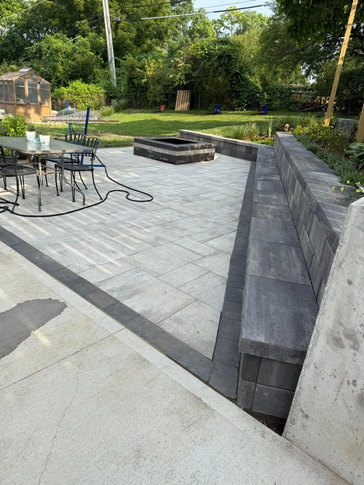 Custom-built wooden deck and stone patio by Wilmer's Landscaping in KS & MO