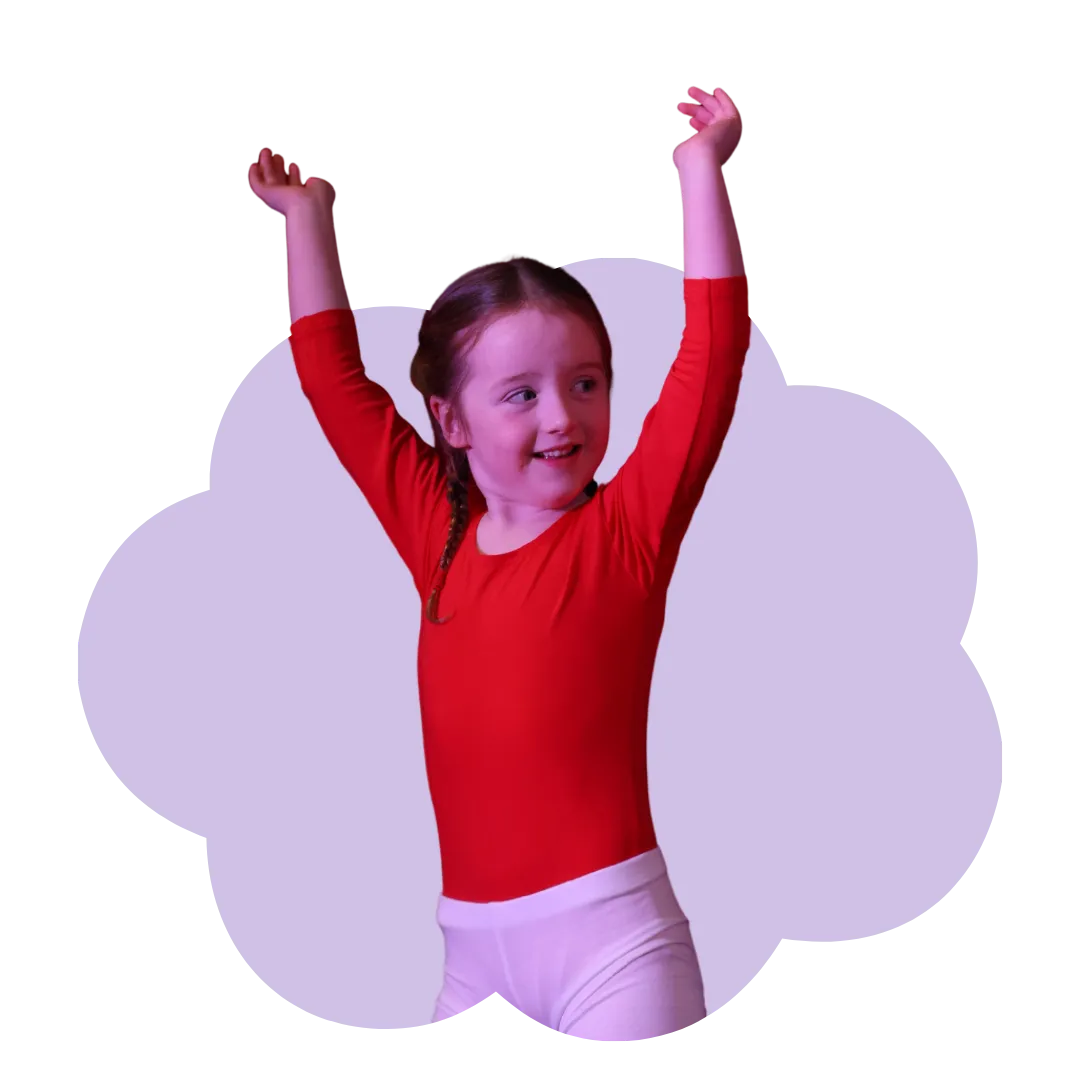 A young girl raising her hand while looking at the side and smiling