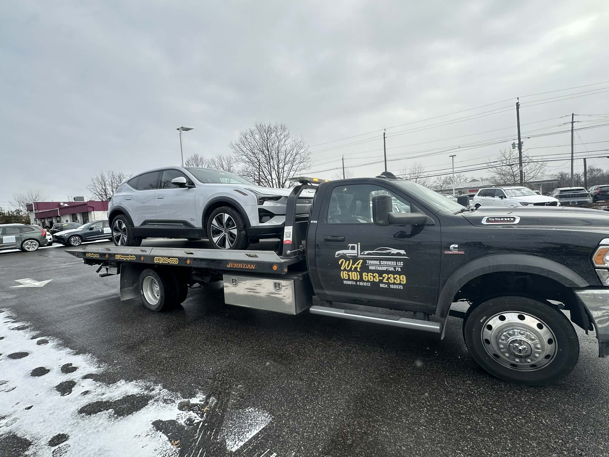 Flatbed tow truck safely transporting a vehicle in Allentown PA