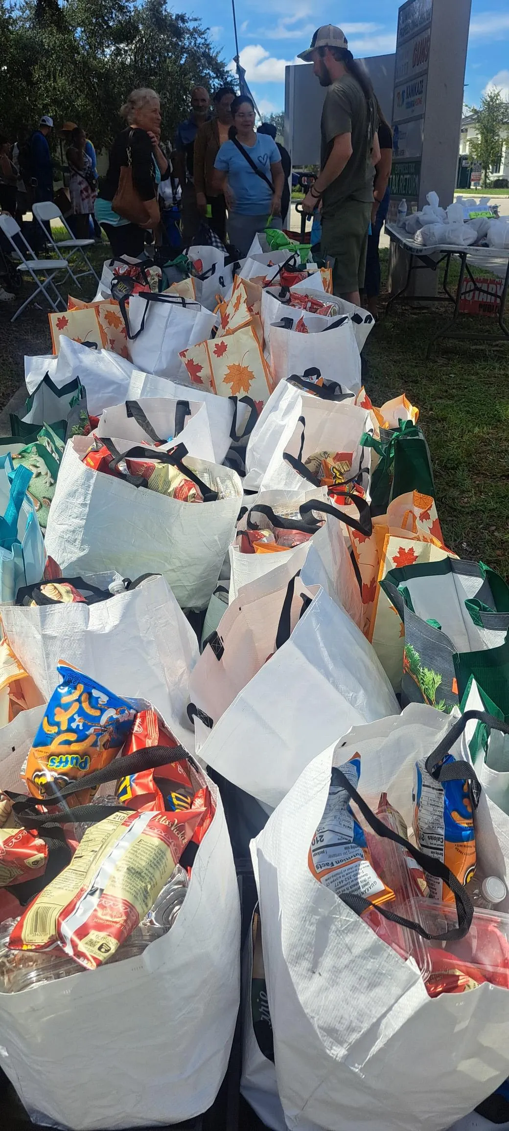 four person holding each others waist at daytime