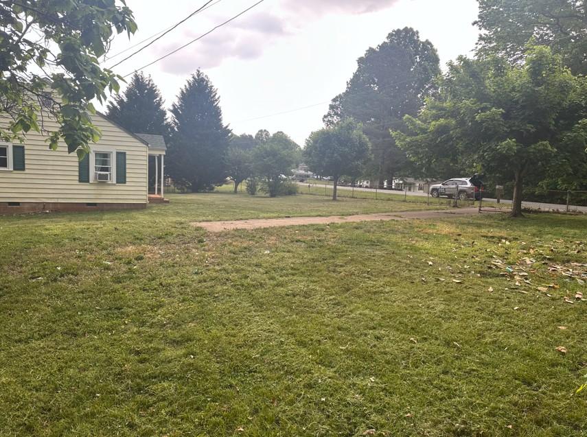 Front yard in Madison NC showing straight mower lines and clean curb appeal after lawn care service