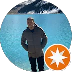 man in front of a blue lake