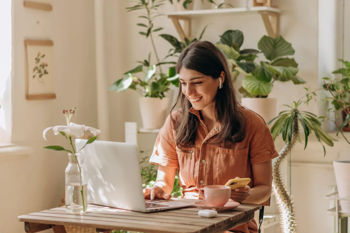 An interior designer looking at their computer and pleased with the results of their SEO