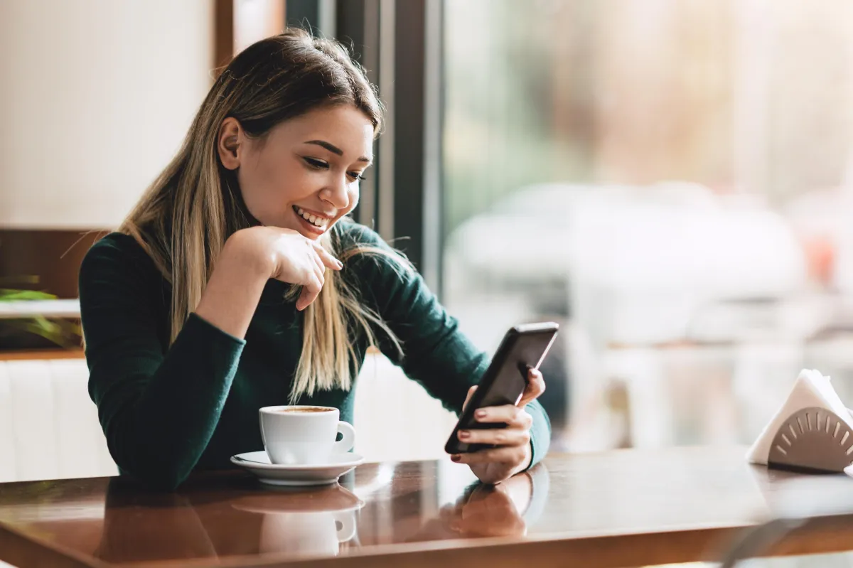 An interior designer looking at their phone happy with their social media posts by Sidemark