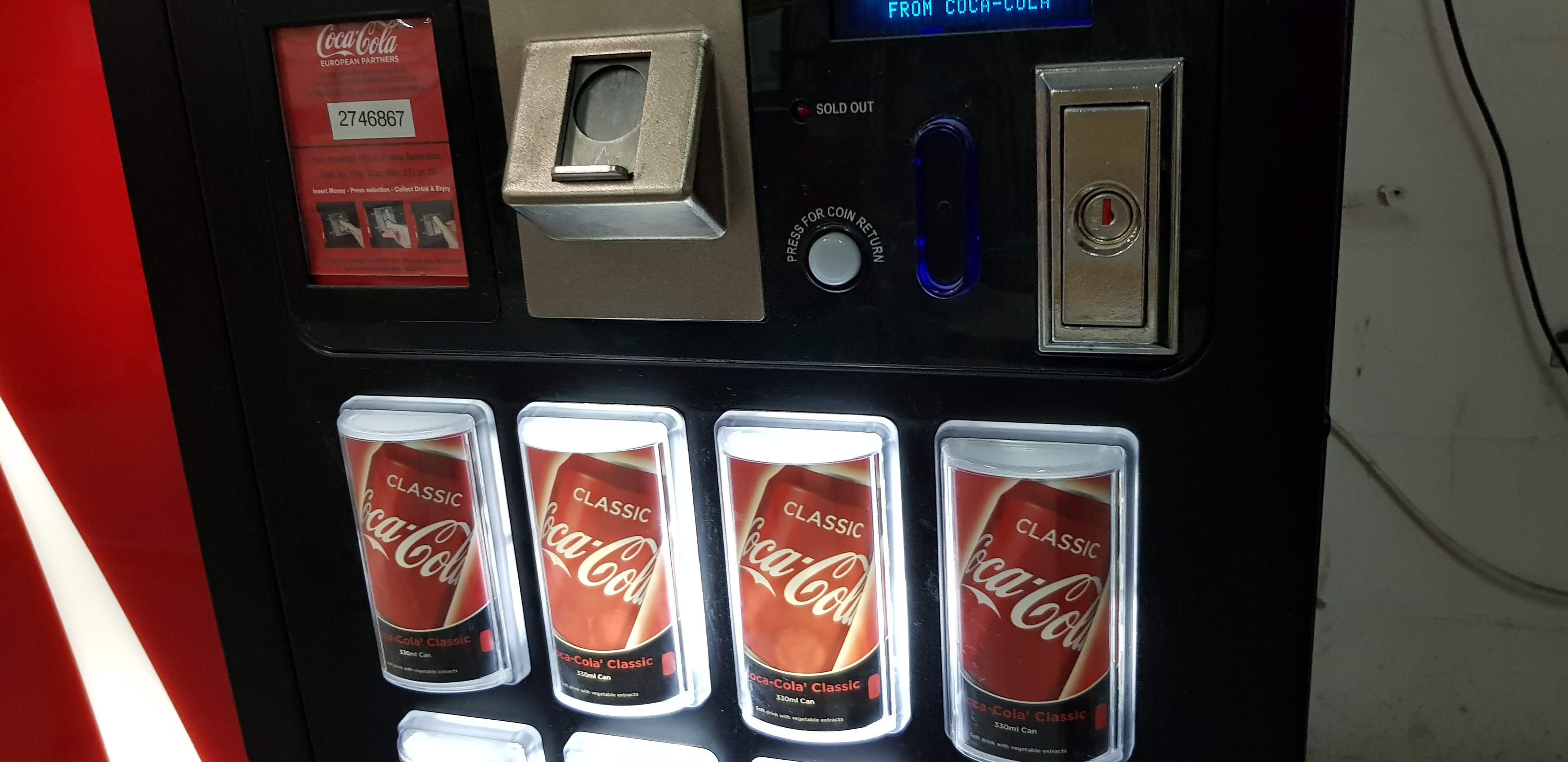 Man walks past vending machines in city