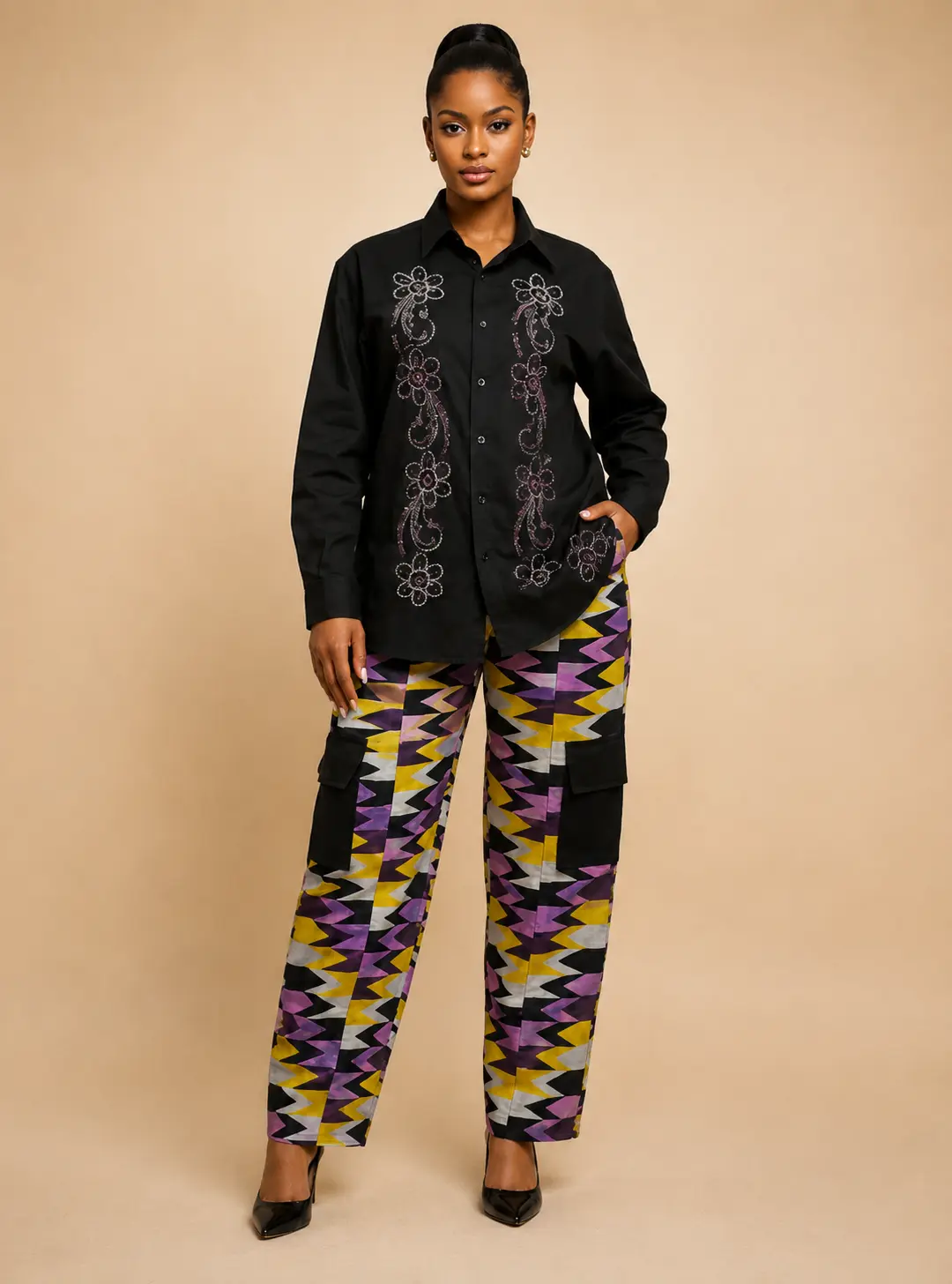 Woman in black rhinestone designed shirt  and lilac trousers