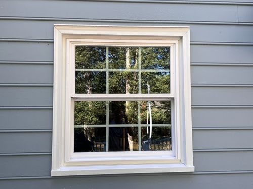 Technician cleaning exterior windows Henrico