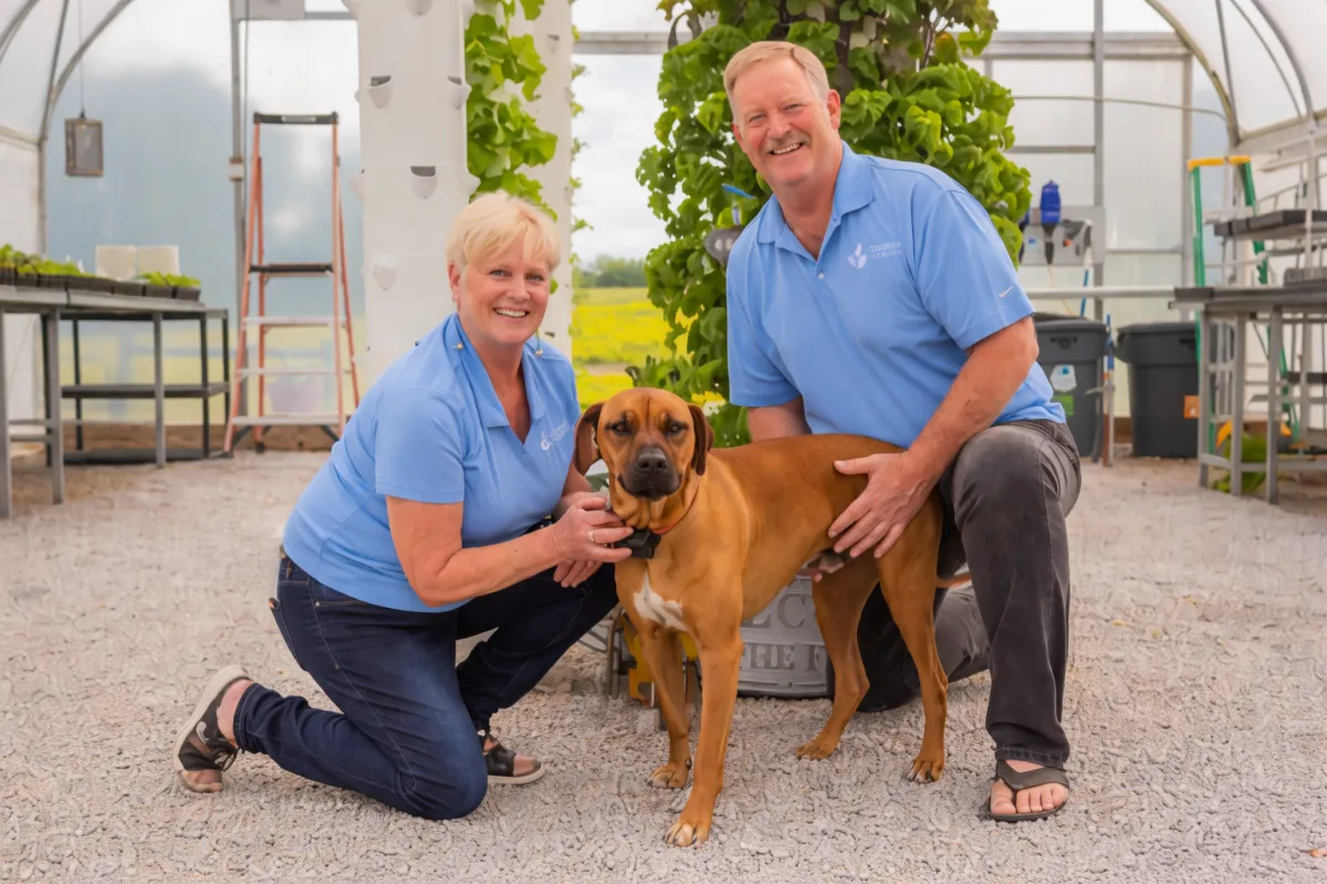 Tennessee Urban Farm Owners and Founders with Dog and tower gardens