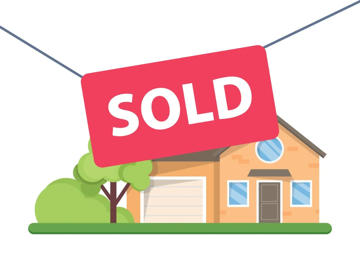 for sale sign in front of a house