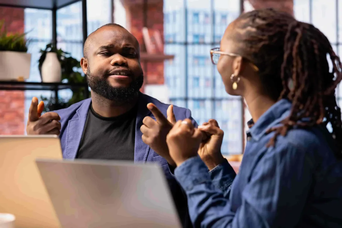 happy-remote-workers-desk-celebrating-task-completion-laptop