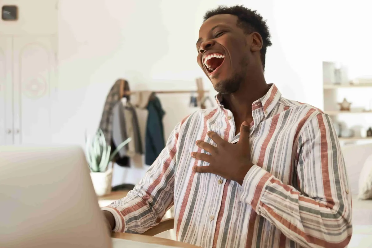 happy-young-afro-american-man-chatting-with-friends-having-video-call-happy-being-good-mood