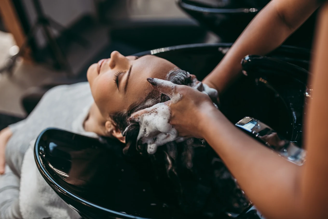 Client receiving luxury hair wash at Experience The Opulent salon McDonough GA