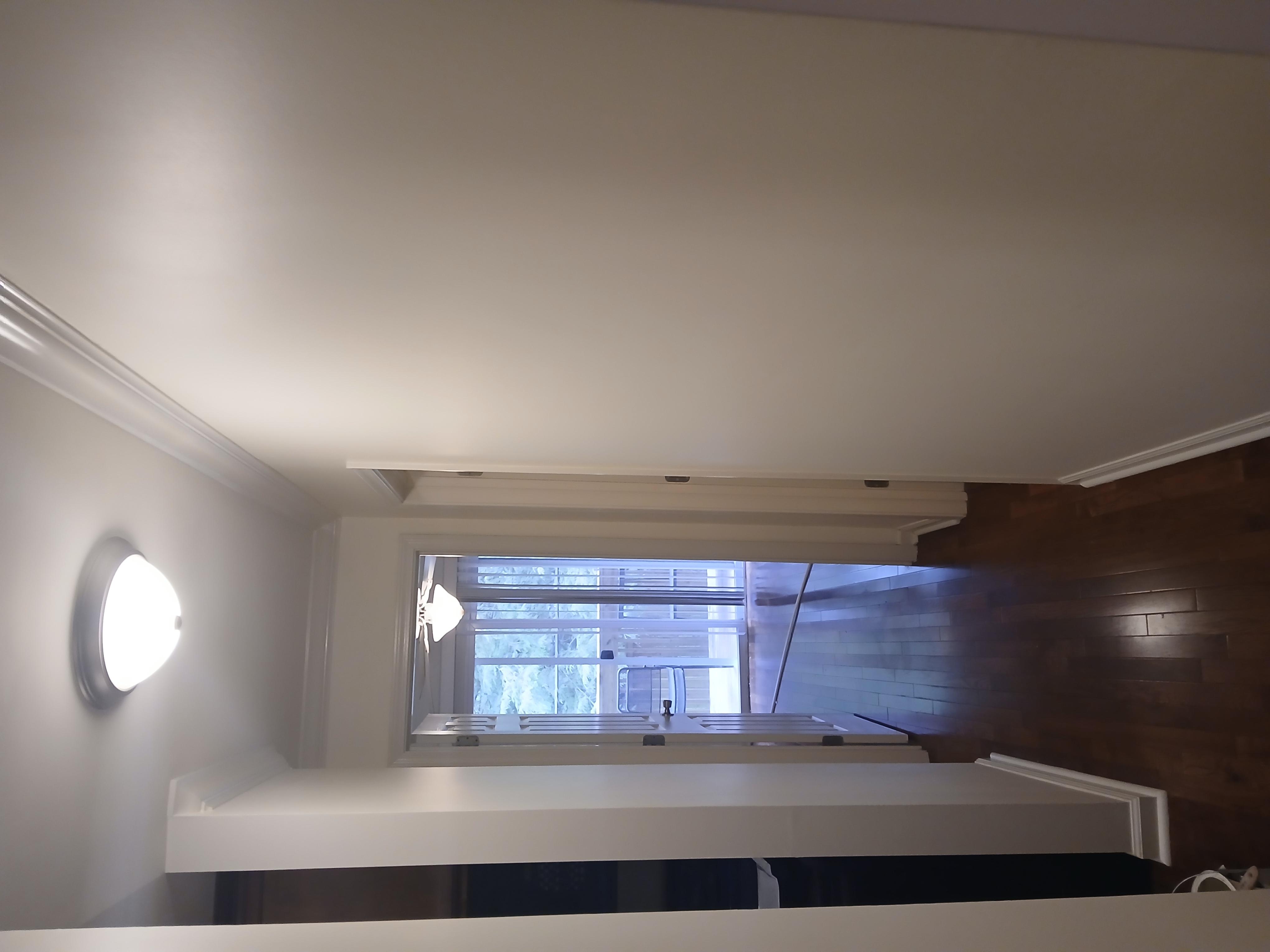 Bright hallway painting with crisp walls and trim that make the space feel open and inviting