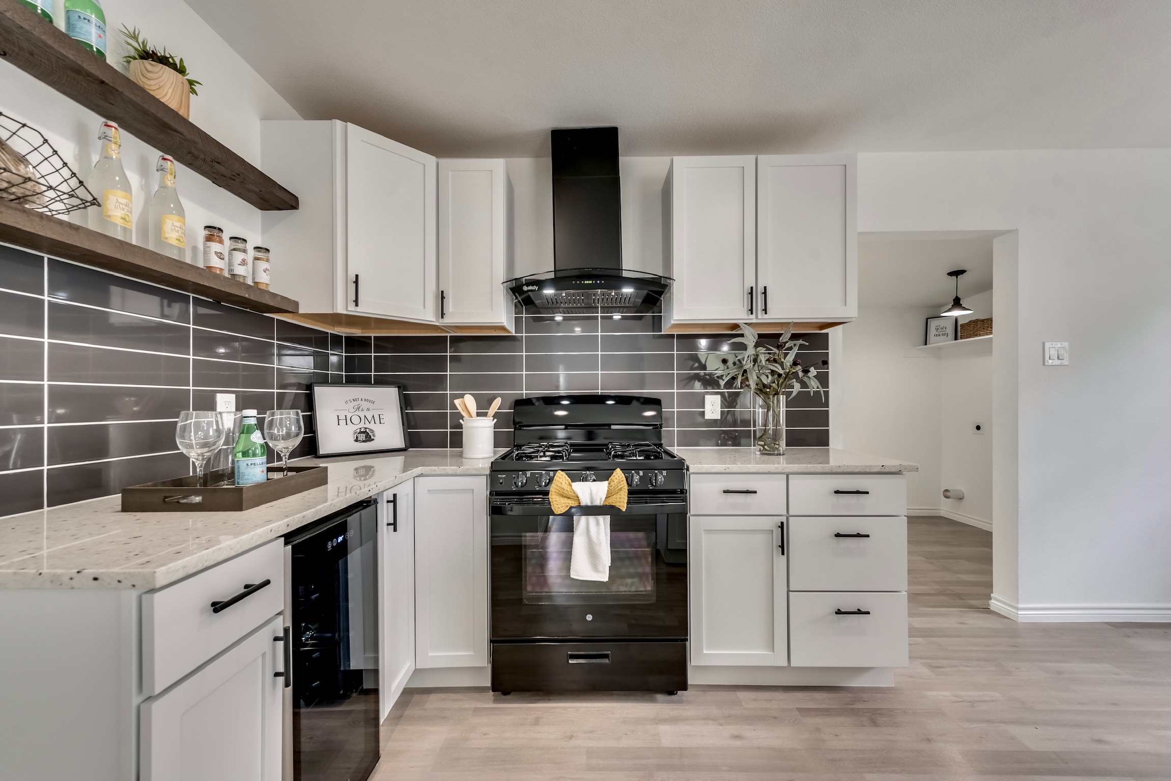 A metal ladder leans against a tiled wall.