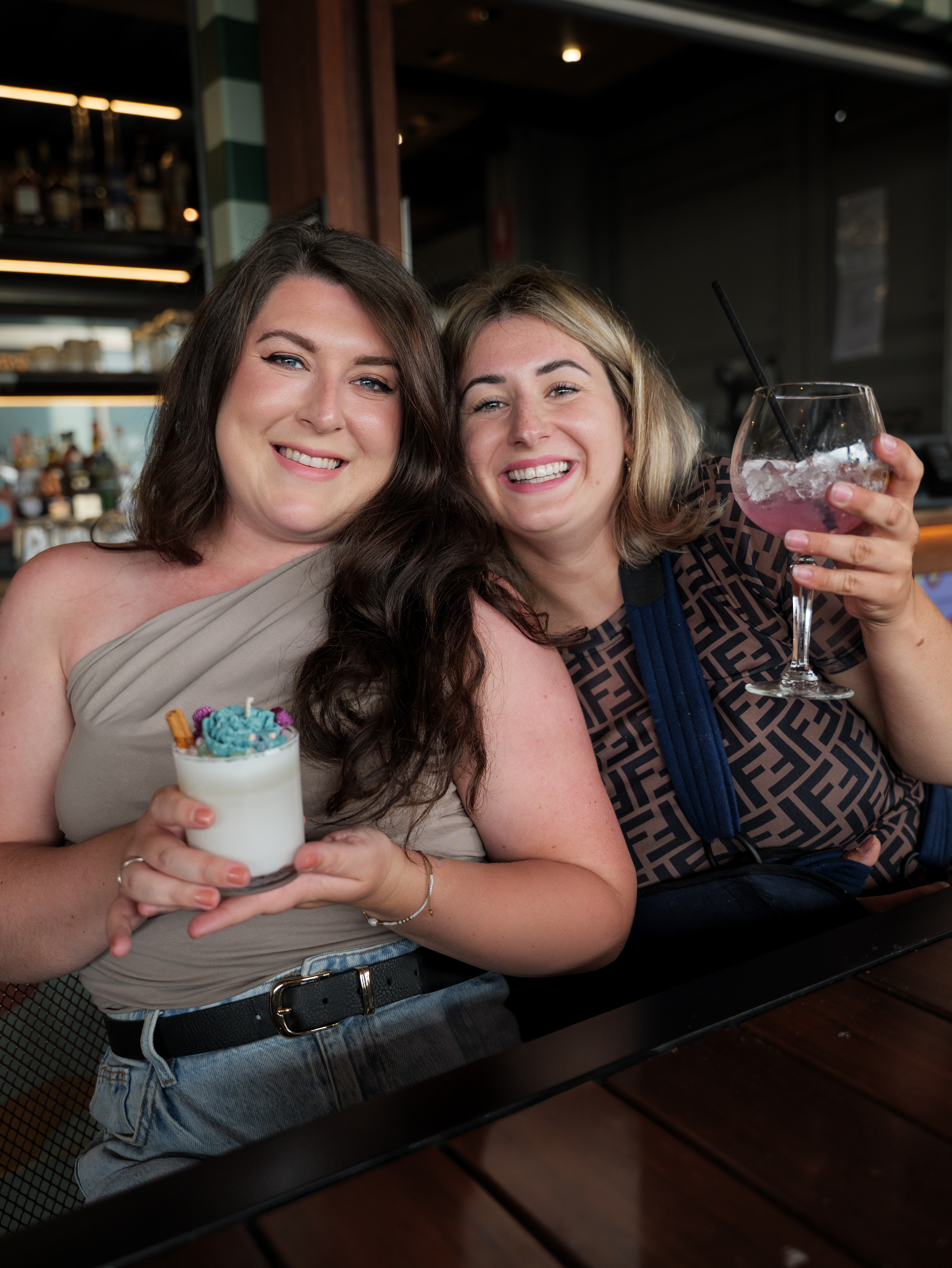 Friends at a hen party pouring scented candle wax together