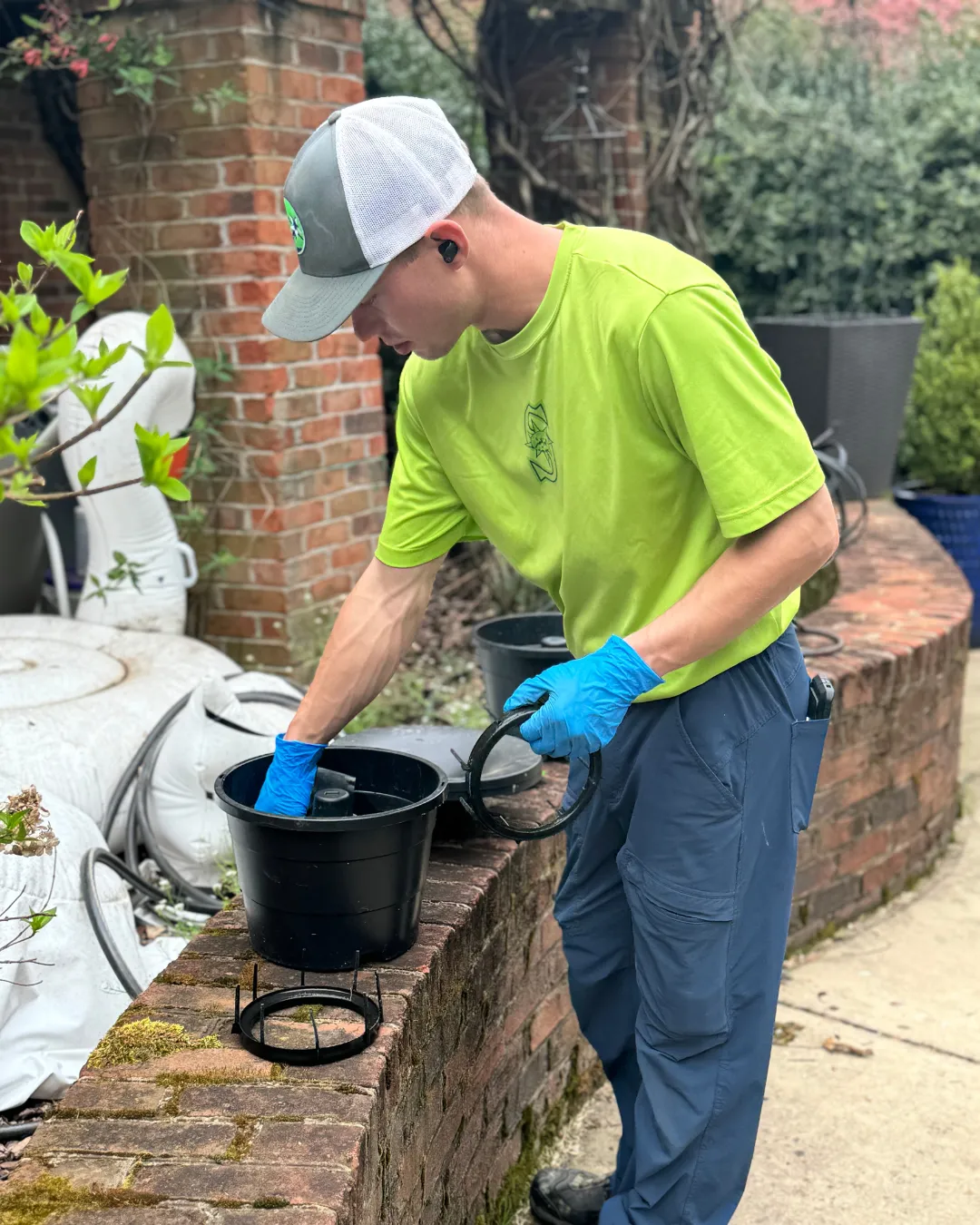 shield pest technician placing a pest trap