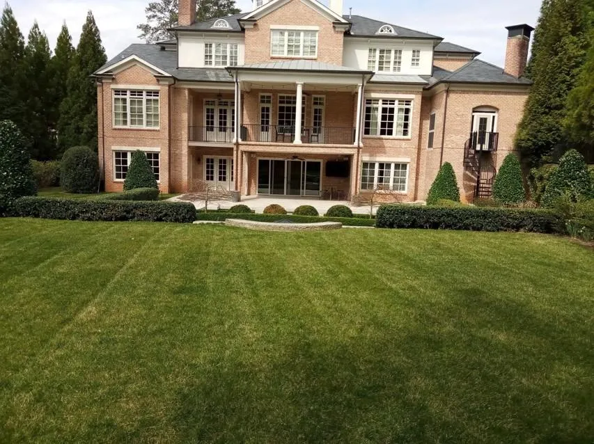 A neatly mowed front yard with clean edges and trimmed grass in an Atlanta neighborhood