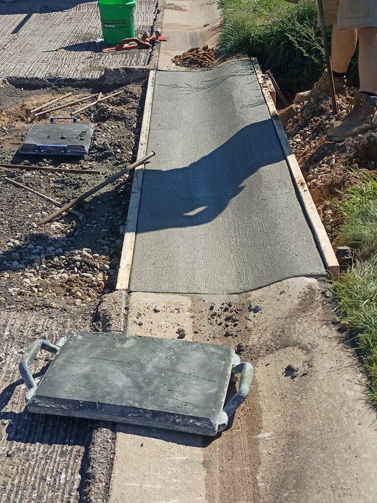 Fresh concrete walkway being poured and finished by Kelly’s Custom Concrete in West Michigan.