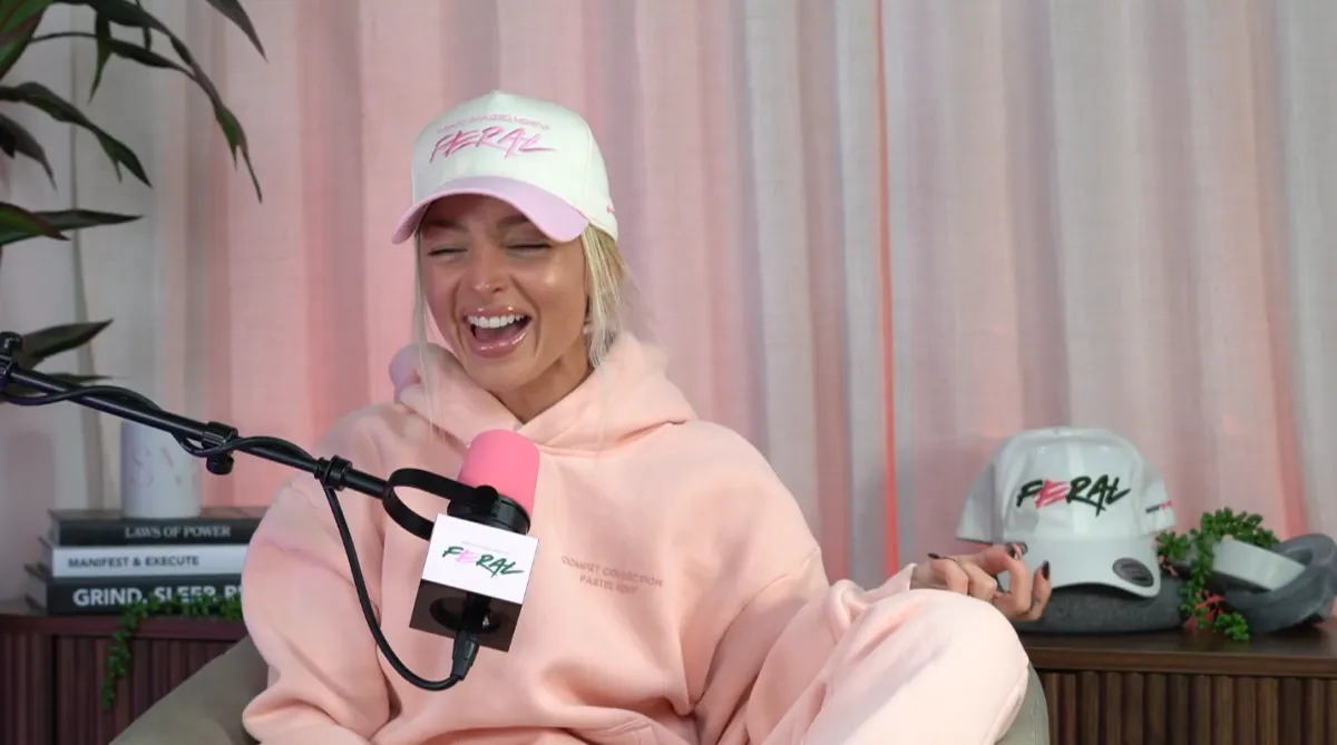 Editorial portrait of Savana Montana founder, a poised woman with natural curls, wearing a minimalist black dress, seated in a modern white chair against a soft green backdrop. The lighting is soft, and the composition is elegant, evoking confidence and creative energy.