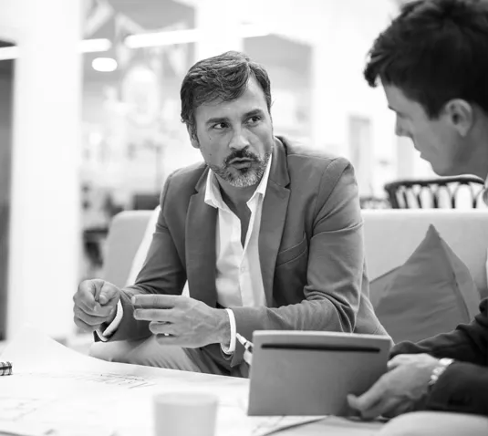 Business professionals in a meeting discussing AI-powered solutions