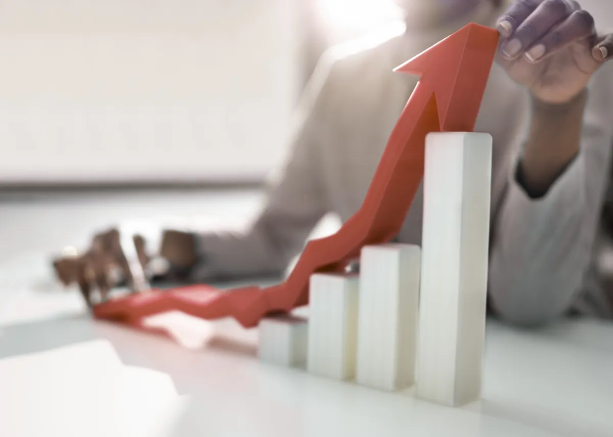 Two businesswomen talking outside modern office building.