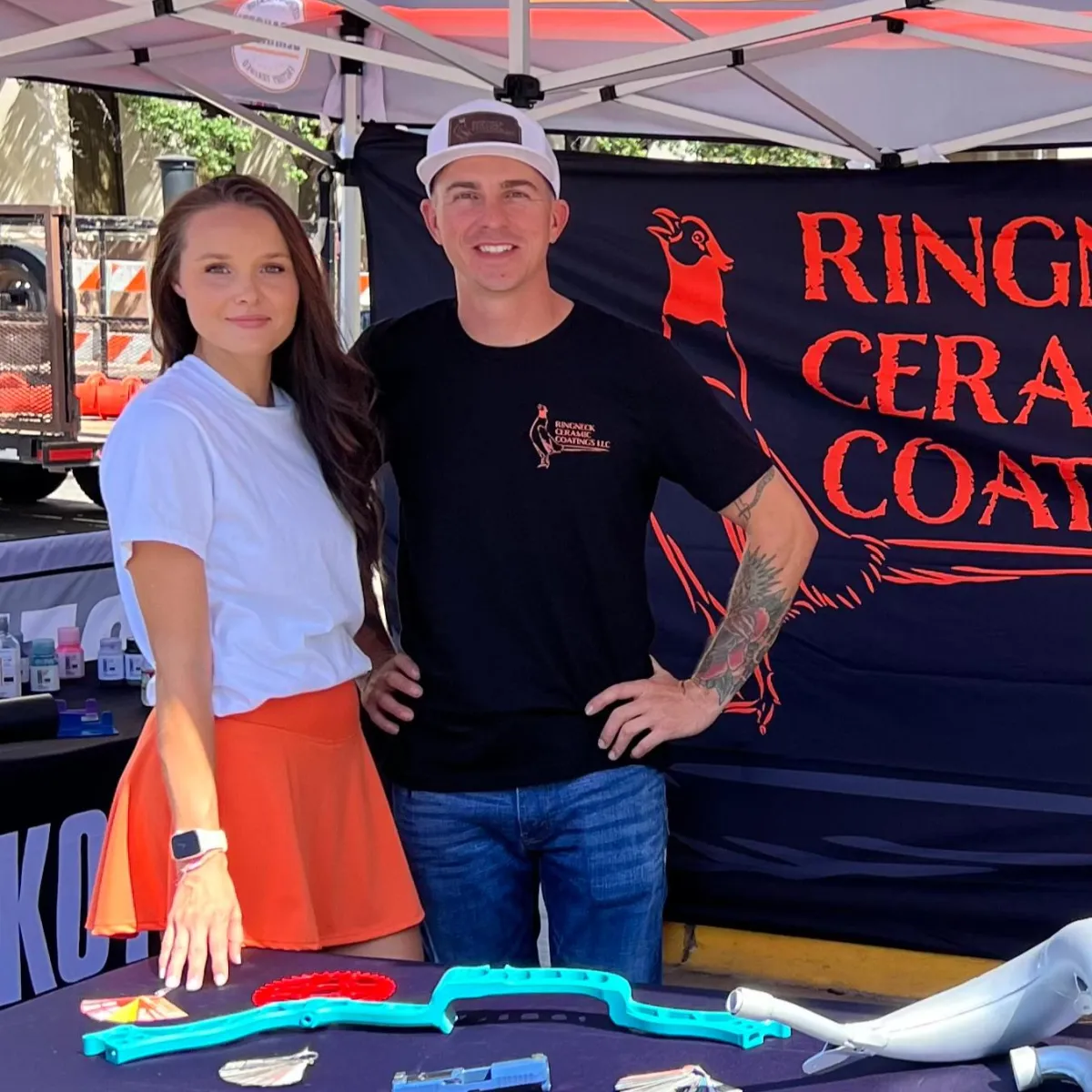 Ringneck Ceramic Coatings team at a local event booth displaying custom ceramic-coated parts.