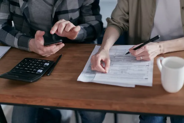 Illustration of a document and calculator representing taxes on a home sale