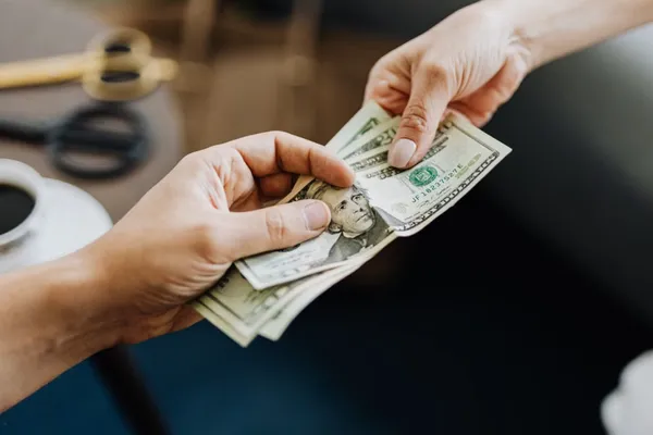 Illustration of cash being offered for a house sale
