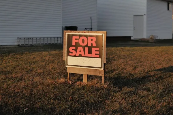 For sale sign in front of a house with a lien