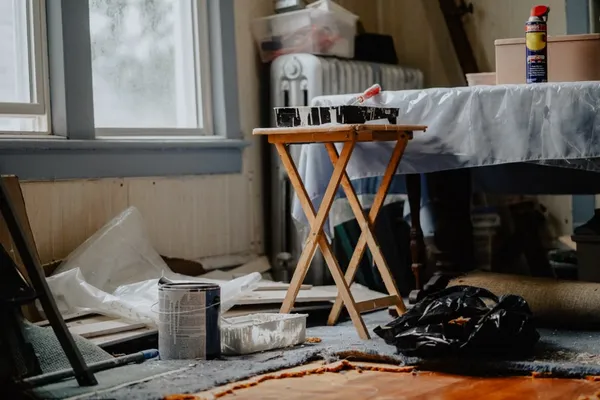 Person doing a home repair, representing a hoarder house needing cleanup