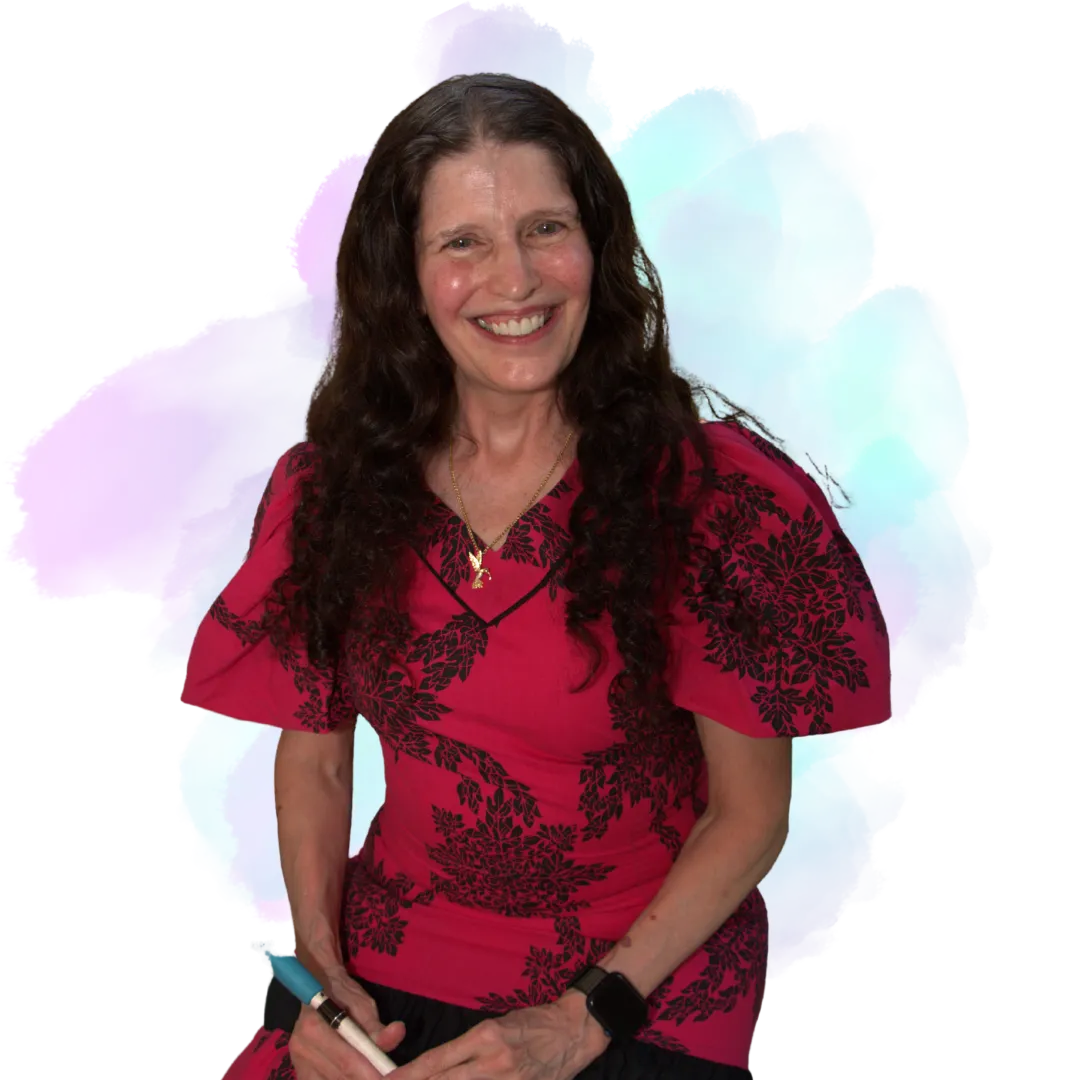 Victoria is smiling warmly, wearing a red patterned top and a simple necklace. She has long, dark wavy hair and stands confidently against a soft, pastel watercolor-style background that feels gentle and uplifting.