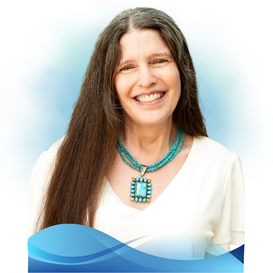 Victoria Essner in a park walking with her mobility cane. Victoria is wearing a floral blue blouse and black pants.