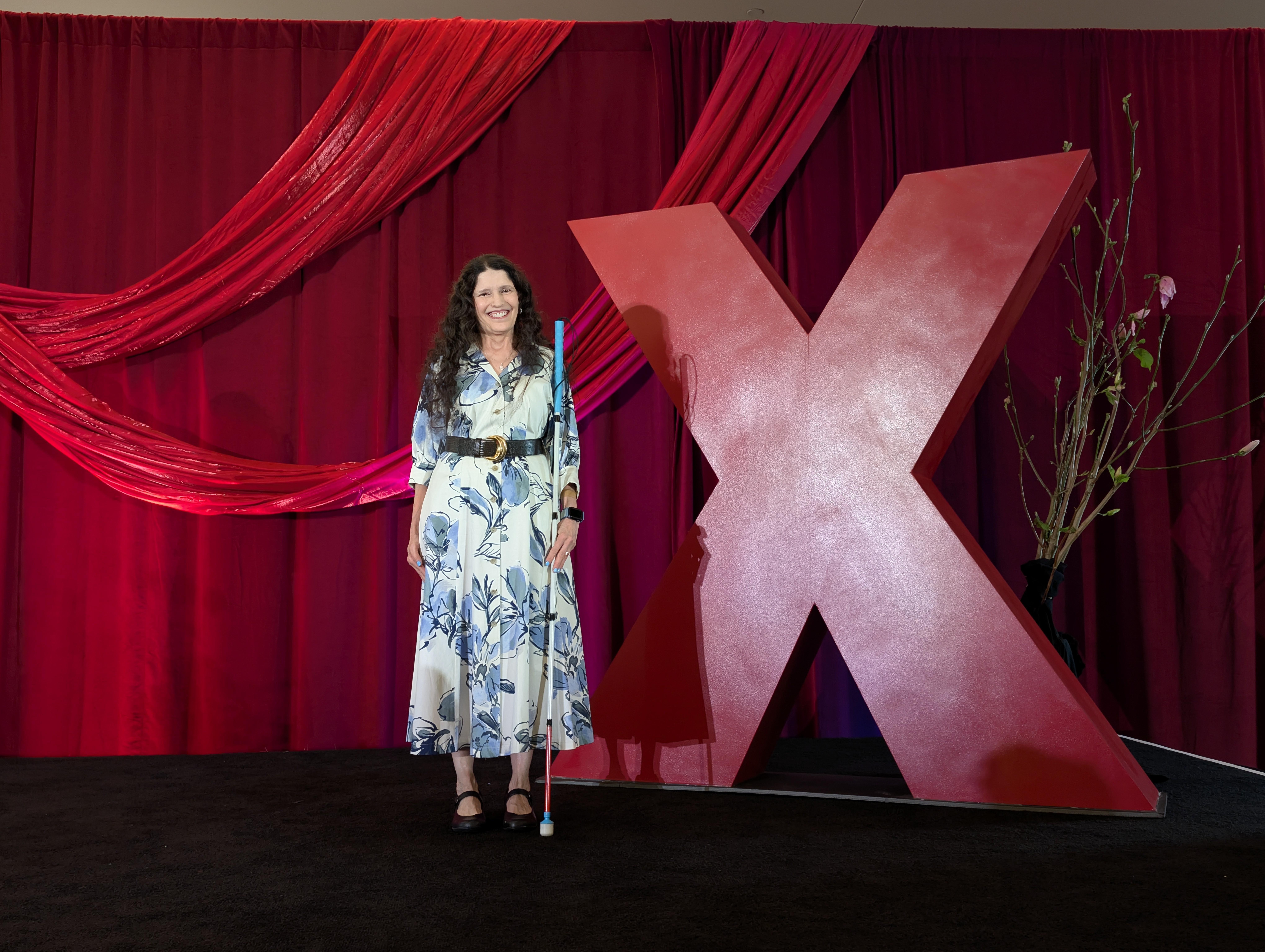 Victoria smiling as speaker at TEDx Las Vegas, assistive technology coach for vision loss independence