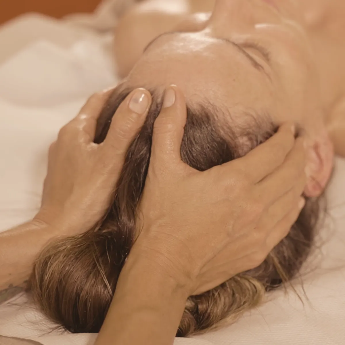 Reiki practitioner holding meditative space with soft natural lighting and sea breeze